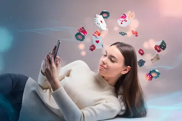 OKPK Casino Games — Enjoy nonstop entertainment A close-up shot of golden coins falling around a spinning roulette wheel, representing immersive casino action at OKPK.